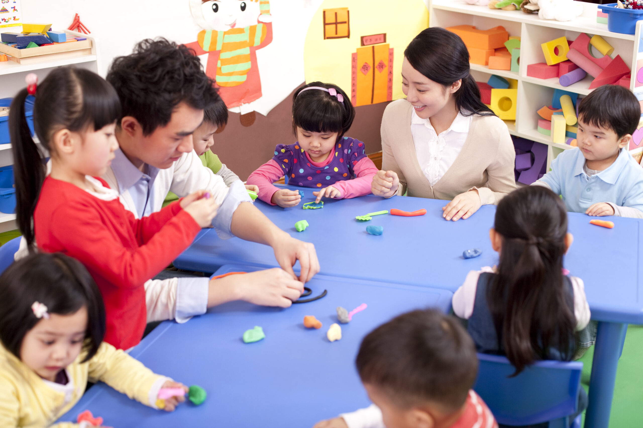 Chinese kindergarten kids playing with plasticine
